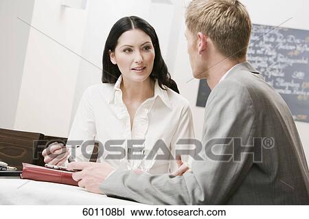 businesswoman and male colleague having conversation at restaurant View Large Photo Image Stock Image - businesswoman and male colleague having conversation at restaurant. Fotosearch