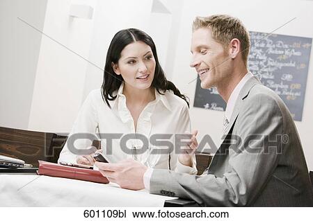 businesswoman and male colleague having conversation at restaurant View Large Photo Image Stock Image - businesswoman and male colleague having conversation at restaurant. Fotosearch