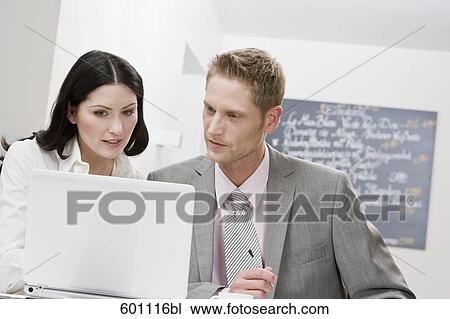 businesswoman and male colleague working in restaurant View Large Photo Image Stock Image - businesswoman and male colleague working in restaurant. Fotosearch