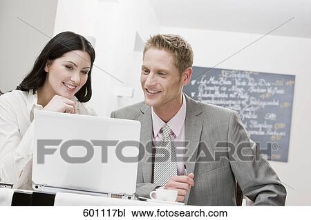 businesswoman and male colleague working in restaurant View Large Photo Image Stock Image - businesswoman and male colleague working in restaurant. Fotosearch