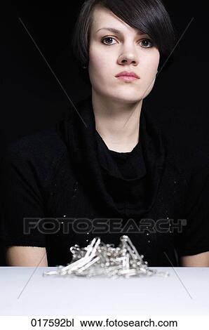 businesswoman looking at stack of paper clips View Large Photo Image Stock Image - businesswoman looking at stack of paper clips. Fotosearch