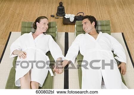 couple relaxing in spa holding hands View Large Photo Image Stock Image - couple relaxing in spa holding hands. Fotosearch