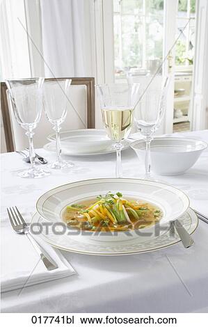 Stock Image - decorated table with soup being served. Fotosearch