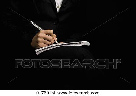 Stock Image - detail of businesswoman writing on pad. Fotosearch