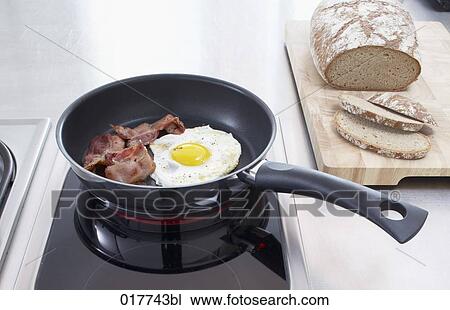 fried egg and bacon in frying pan View Large Photo Image Stock Image - fried egg and bacon in frying pan. Fotosearch