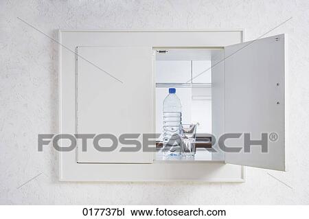 Stock Image - glass of water and plastic bottle in pass-through to kitchen. Fotosearch