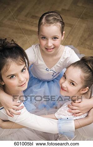 Stock Image - group of three young ballet dancers in close embrace. Fotosearch