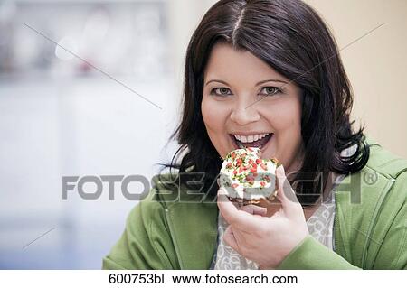 headshot of overweight woman eating bread with cream cheese View Large Photo Image Stock Image - headshot of overweight woman eating bread with cream cheese. Fotosearch