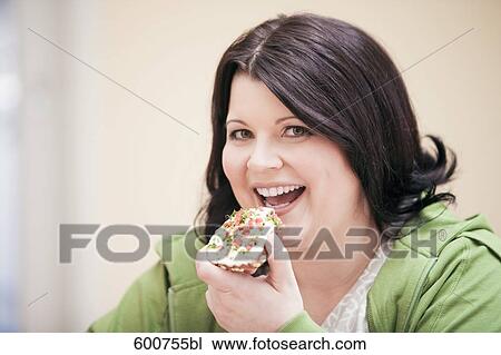 headshot of overweight woman eating bread with cream cheese View Large Photo Image Stock Image - headshot of overweight woman eating bread with cream cheese. Fotosearch