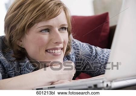 headshot of young woman at home working with laptop computer View Large Photo Image Stock Image - headshot of young woman at home working with laptop computer. Fotosearch