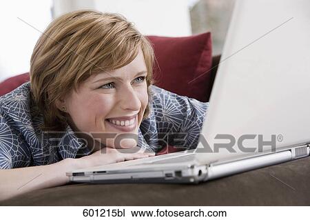 headshot of young woman at home working with laptop computer View Large Photo Image Stock Image - headshot of young woman at home working with laptop computer. Fotosearch