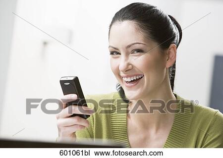 headshot of young woman with mobile phone View Large Photo Image Stock Image - headshot of young woman with mobile phone. Fotosearch