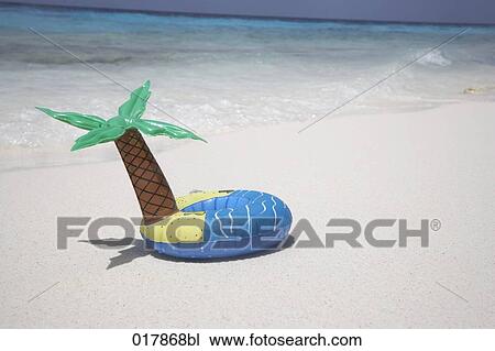 inflatable in shape of island with palm tree lying on sandy beach View Large Photo Image Stock Image - inflatable in shape of island with palm tree lying on sandy beach. Fotosearch