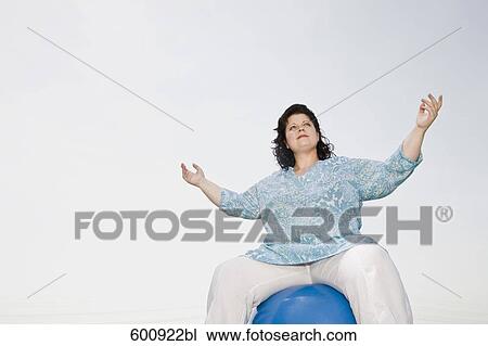 low angle view of overweight woman doing exercises with blue ball View Large Photo Image Stock Image - low angle view of overweight woman doing exercises with blue ball. Fotosearch