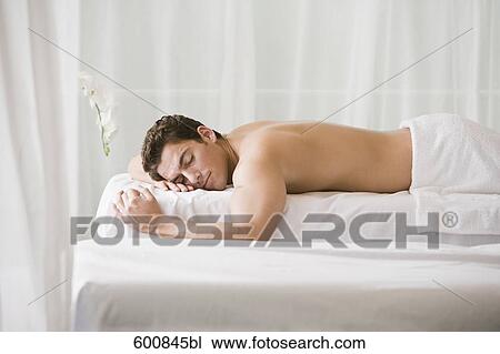 man lying on massage bench View Large Photo Image Stock Image - man lying on massage bench. Fotosearch
