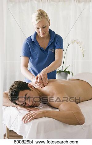 man lying on massage bench undergoing massage treatment View Large Photo Image Stock Image - man lying on massage bench undergoing massage treatment. Fotosearch