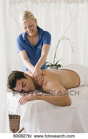 man lying on massage bench undergoing massage treatment View Large Photo Image Stock Image - man lying on massage bench undergoing massage treatment. Fotosearch