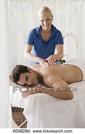 man lying on massage bench undergoing massage treatment View Large Photo Image Stock Image - man lying on massage bench undergoing massage treatment. Fotosearch