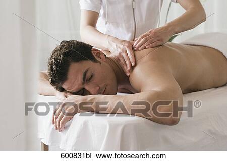 man lying on massage bench undergoing massage treatment View Large Photo Image Stock Image - man lying on massage bench undergoing massage treatment. Fotosearch