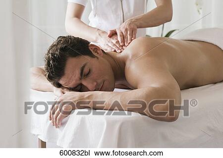 man lying on massage bench undergoing massage treatment View Large Photo Image Stock Image - man lying on massage bench undergoing massage treatment. Fotosearch