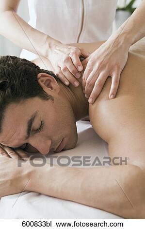 man lying on massage bench undergoing massage treatment View Large Photo Image Stock Image - man lying on massage bench undergoing massage treatment. Fotosearch