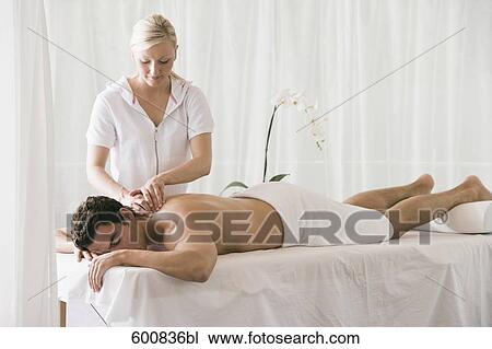 man lying on massage bench undergoing massage treatment View Large Photo Image Stock Image - man lying on massage bench undergoing massage treatment. Fotosearch