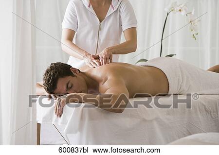 man lying on massage bench undergoing massage treatment View Large Photo Image Stock Image - man lying on massage bench undergoing massage treatment. Fotosearch