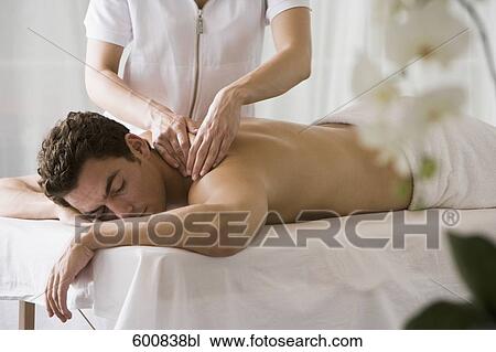 man lying on massage bench undergoing massage treatment View Large Photo Image Stock Image - man lying on massage bench undergoing massage treatment. Fotosearch
