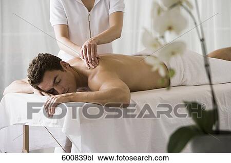 man lying on massage bench undergoing massage treatment View Large Photo Image Stock Image - man lying on massage bench undergoing massage treatment. Fotosearch