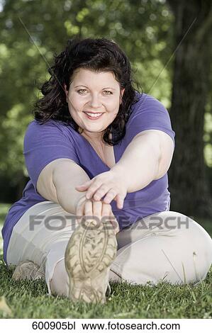 overweight woman doing stretching exercises in park View Large Photo Image Stock Image - overweight woman doing stretching exercises in park. Fotosearch