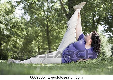 overweight woman doing stretching exercises in park View Large Photo Image Stock Image - overweight woman doing stretching exercises in park. Fotosearch