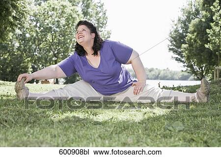 overweight woman doing stretching exercises in park View Large Photo Image Stock Image - overweight woman doing stretching exercises in park. Fotosearch