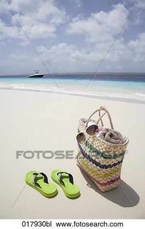 pair of flip flops and bag on sandy beach View Large Photo Image Stock Image - pair of flip flops and bag on sandy beach. Fotosearch