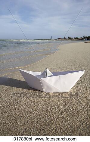 paper boat lying on sandy beach View Large Photo Image Stock Image - paper boat lying on sandy beach. Fotosearch