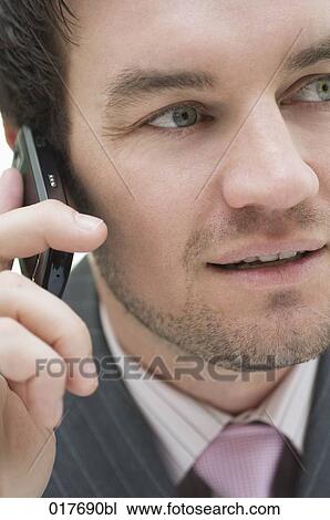 Stock Image - portrait of businessman talking on mobile phone. Fotosearch