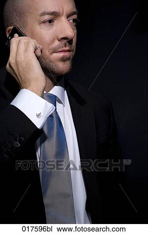 Stock Image - portrait of businessman with mobile phone. Fotosearch