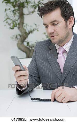 Stock Image - portrait of businessman with telephone. Fotosearch