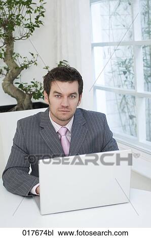 portrait of businessman working with laptop computer View Large Photo Image Stock Image - portrait of businessman working with laptop computer. Fotosearch
