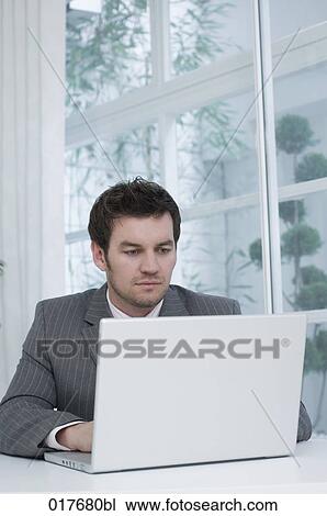 portrait of businessman working with laptop computer View Large Photo Image Stock Image - portrait of businessman working with laptop computer. Fotosearch