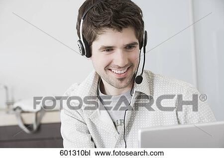 Stock Image - portrait of man wearing headset. Fotosearch