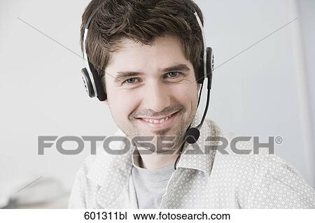 Stock Image - portrait of man wearing headset. Fotosearch