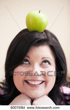 portrait of overweight woman balancing apple on her head View Large Photo Image Stock Image - portrait of overweight woman balancing apple on her head. Fotosearch