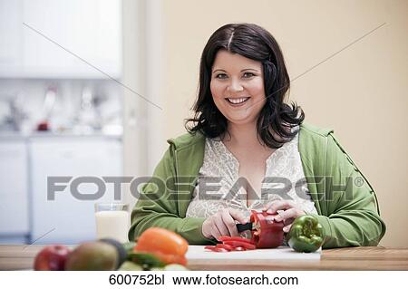 portrait of overweight woman in kitcghen cutting red pepper View Large Photo Image Stock Image - portrait of overweight woman in kitcghen cutting red pepper. Fotosearch