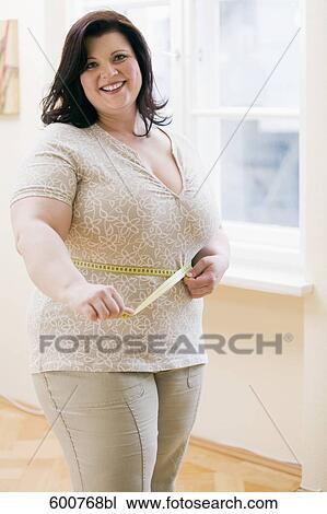 portrait of overweight womancheckingf waistline with tape measure View Large Photo Image Stock Image - portrait of overweight womancheckingf waistline with tape measure. Fotosearch