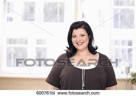 Stock Image - portrait of smiling overweight woman. Fotosearch