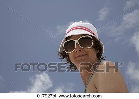 portrait of smiling woman wearing sunglases and white hat View Large Photo Image Stock Image - portrait of smiling woman wearing sunglases and white hat. Fotosearch