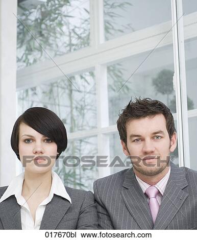 Stock Image - portrait of two smiling business people. Fotosearch