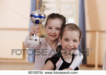 portrait of two young ballet dancers one holding trophy View Large Photo Image Stock Image - portrait of two young ballet dancers one holding trophy. Fotosearch