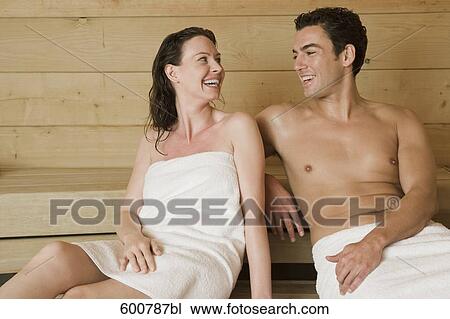 Stock Image - portrait of woman and man relaxing in sauna. Fotosearch