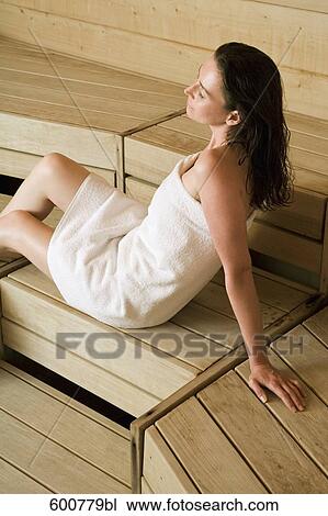 Stock Image - portrait of woman relaxing in sauna. Fotosearch